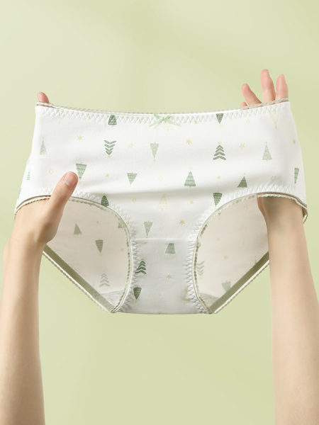 White patterned women’s underwear held up by hands
