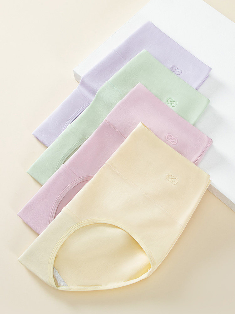 Pastel folded underwear laid flat on a light background