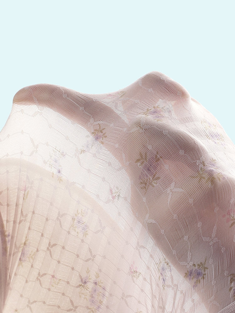 Sheer floral fabric with soft pastel tones