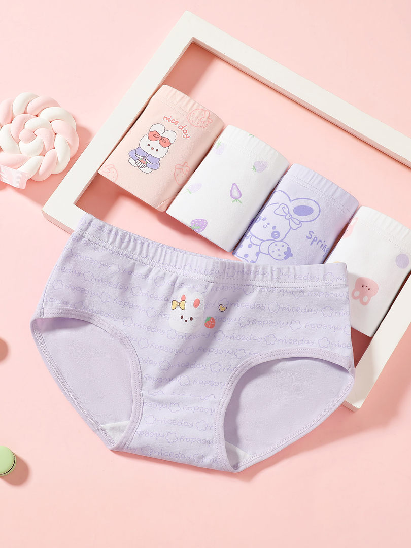Pastel cartoon-print women's briefs displayed on a pink background
