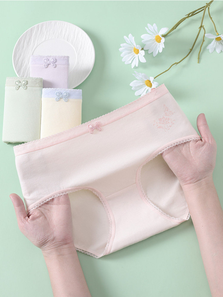 Pastel-colored women’s underwear briefs held up for display