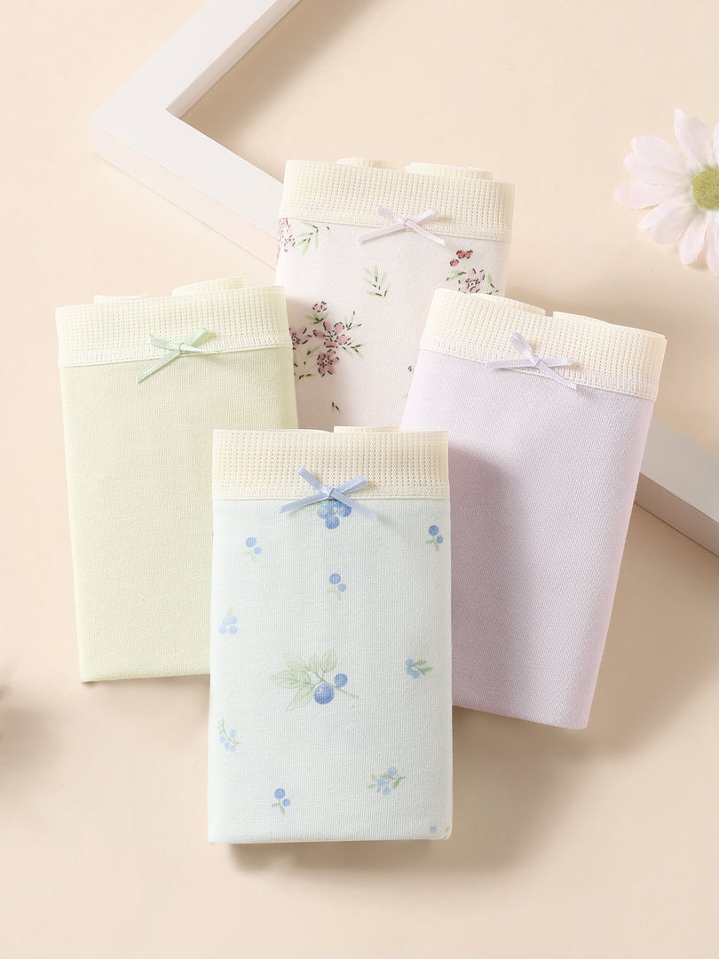 Pastel floral women's underwear panties arranged on a beige background