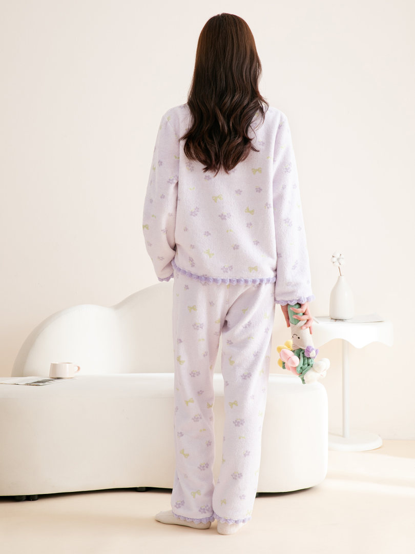 Model wearing a light purple patterned pajama set with matching pants