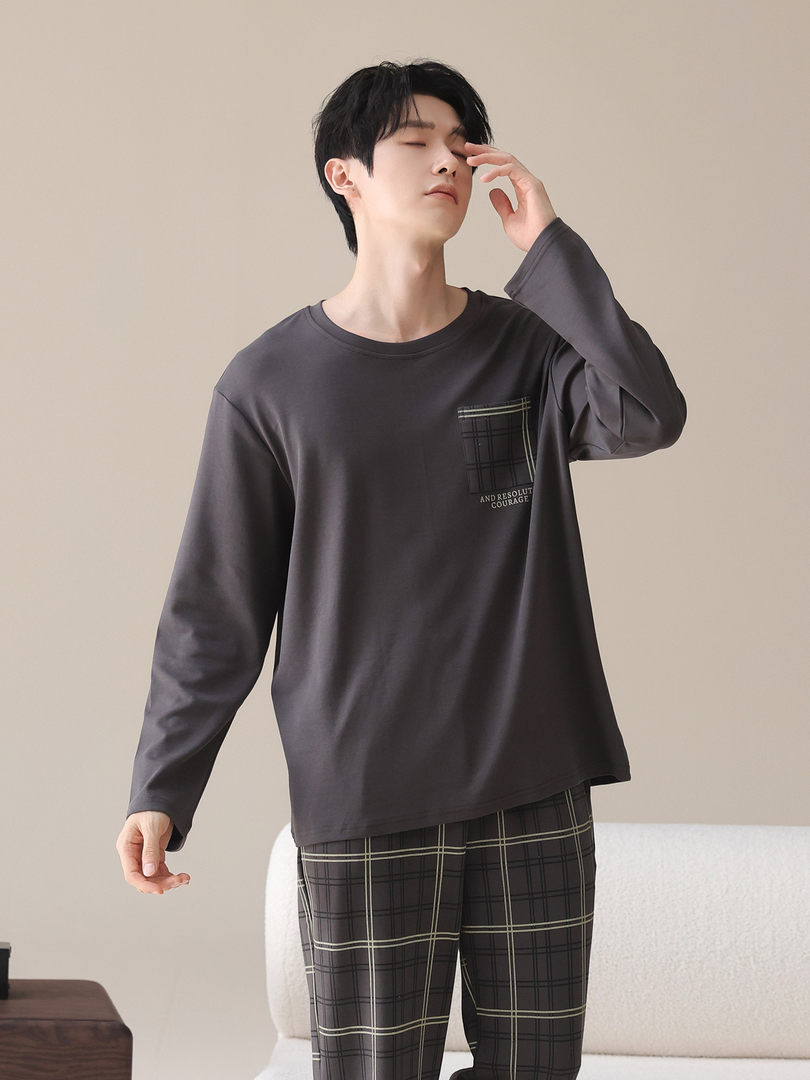 Man modeling a dark long-sleeve loungewear set with plaid pants