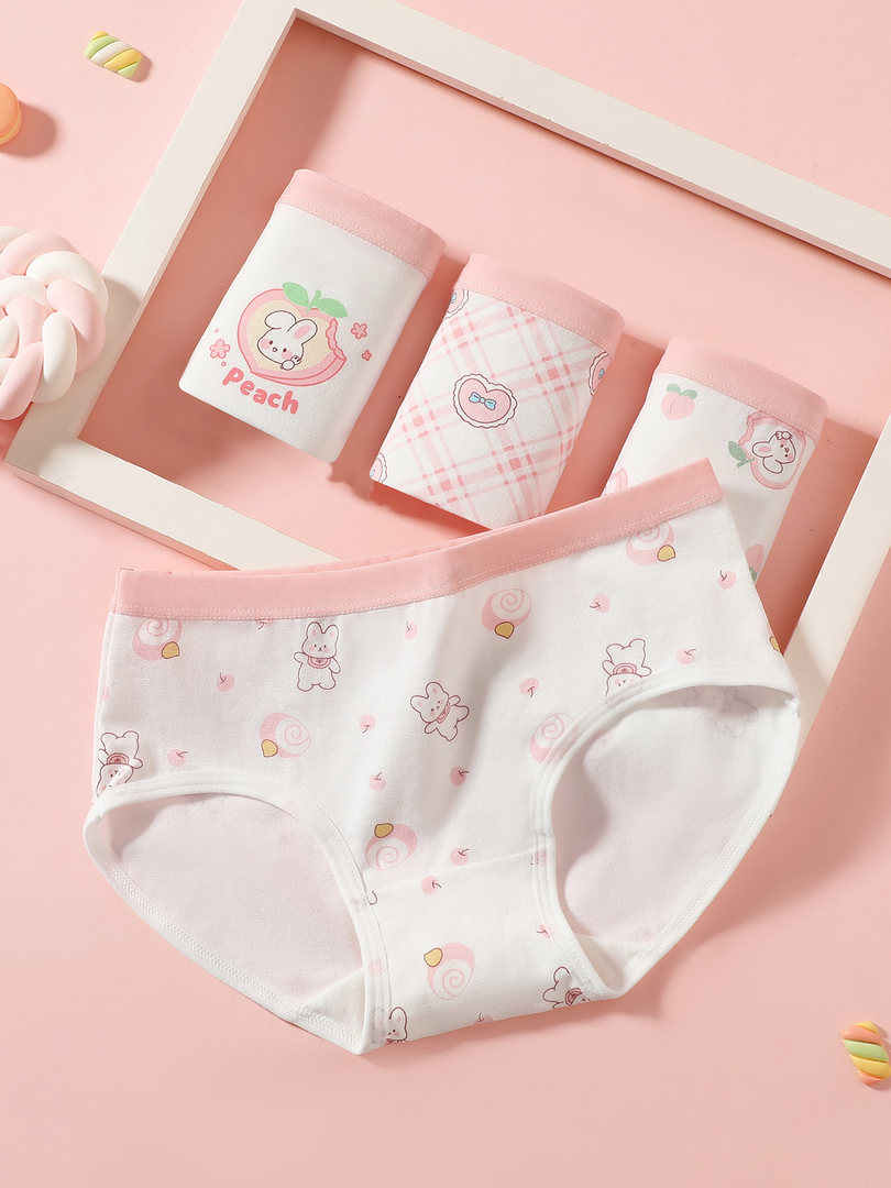 Pink and white cartoon-print women's underwear set laid flat