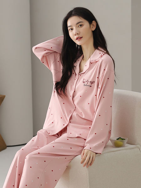 Pink heart-patterned pajama loungewear set worn by a model
