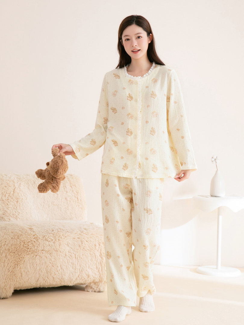 Model wearing a cream patterned long-sleeve pajama set with pants