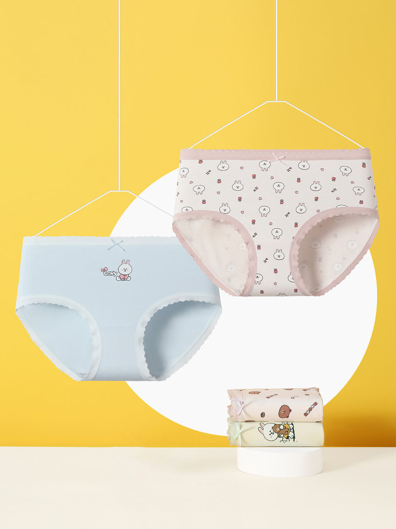 Cute pastel women's underwear briefs displayed on hangers