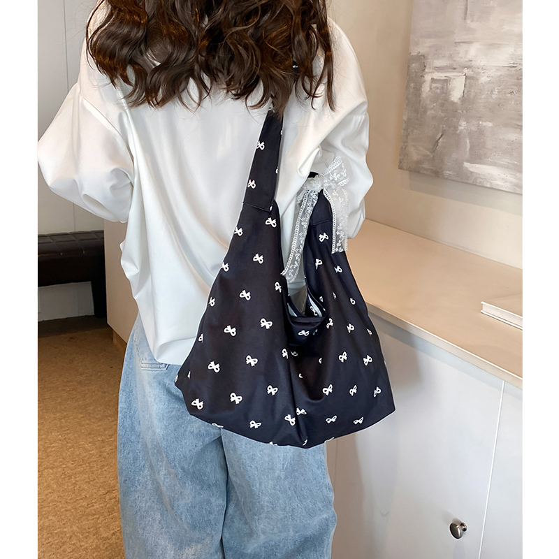 设计师帆布包女2025新款大学生上课包大容量蝴蝶结松弛感腋下包潮