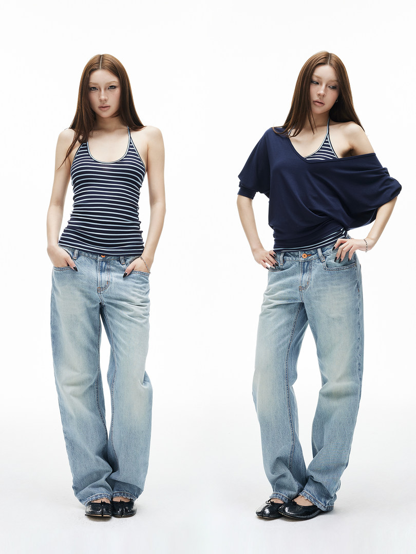 Model wearing striped tank top with loose light-wash jeans