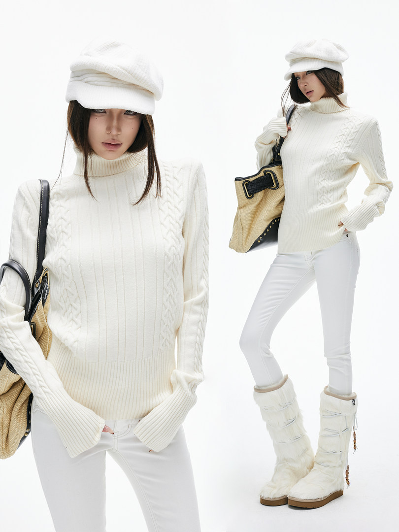 Model wearing a white cable-knit turtleneck sweater with white pants and winter accessories