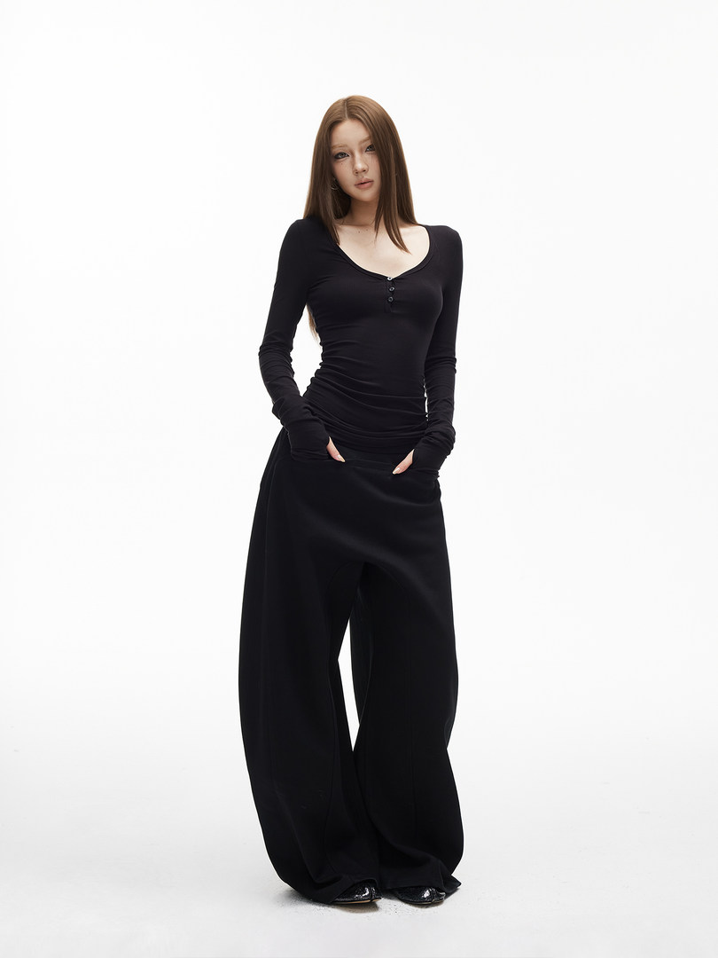 Black long-sleeve fitted top with wide-leg pants worn by a model on a white background
