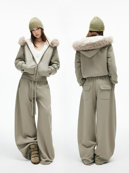 Woman wearing a khaki winter streetwear outfit with fur-trimmed hooded jacket, wide-leg pants, and beanie