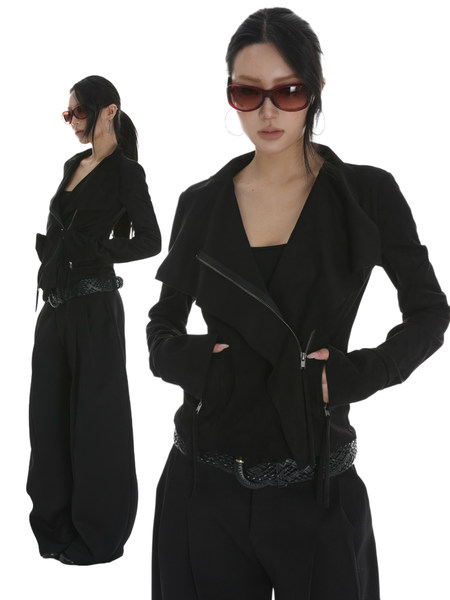 Black tailored jacket and wide-leg pants worn by a model with sunglasses
