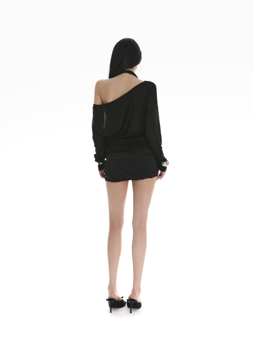 Woman wearing a black off-shoulder mini dress with heels, shown from the back