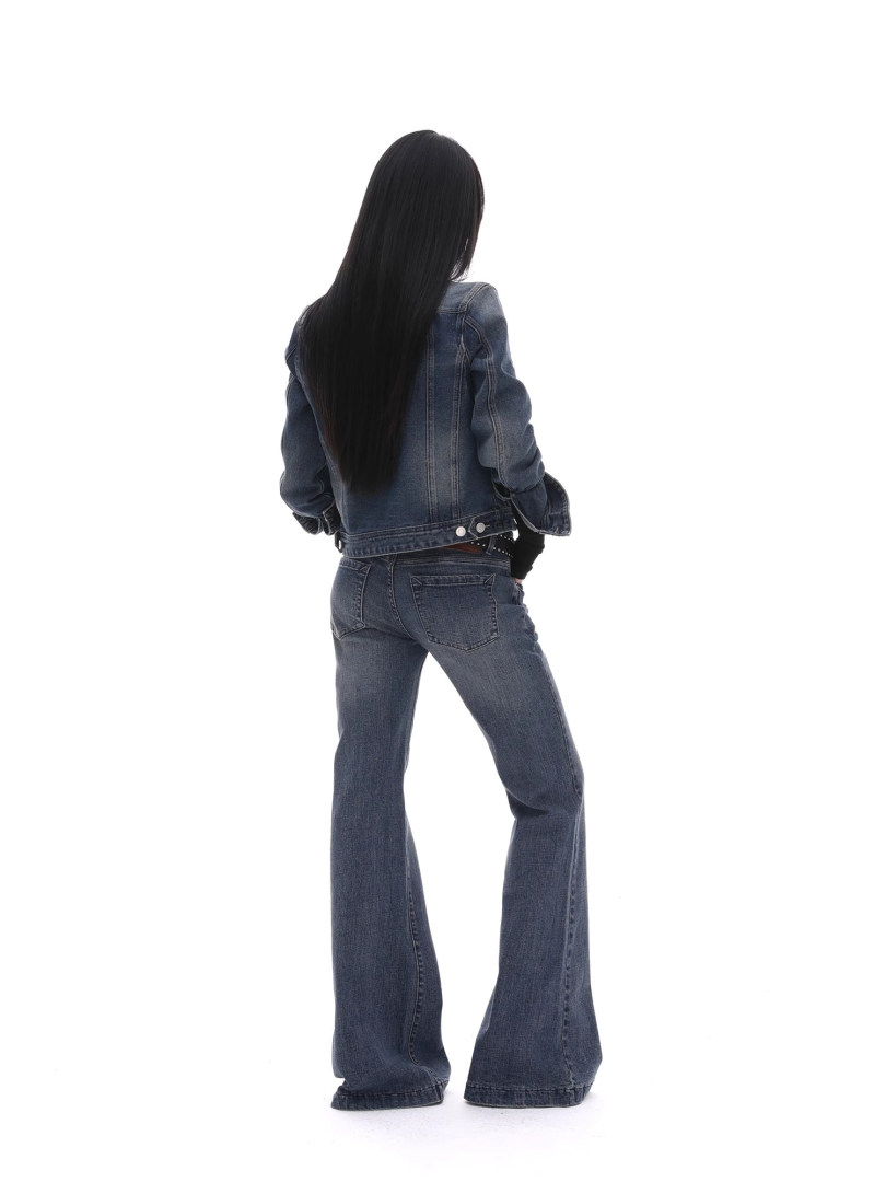 Model wearing a denim jacket and flared jeans on a white background