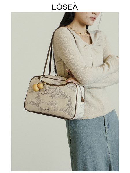 Model wearing a patterned shoulder handbag