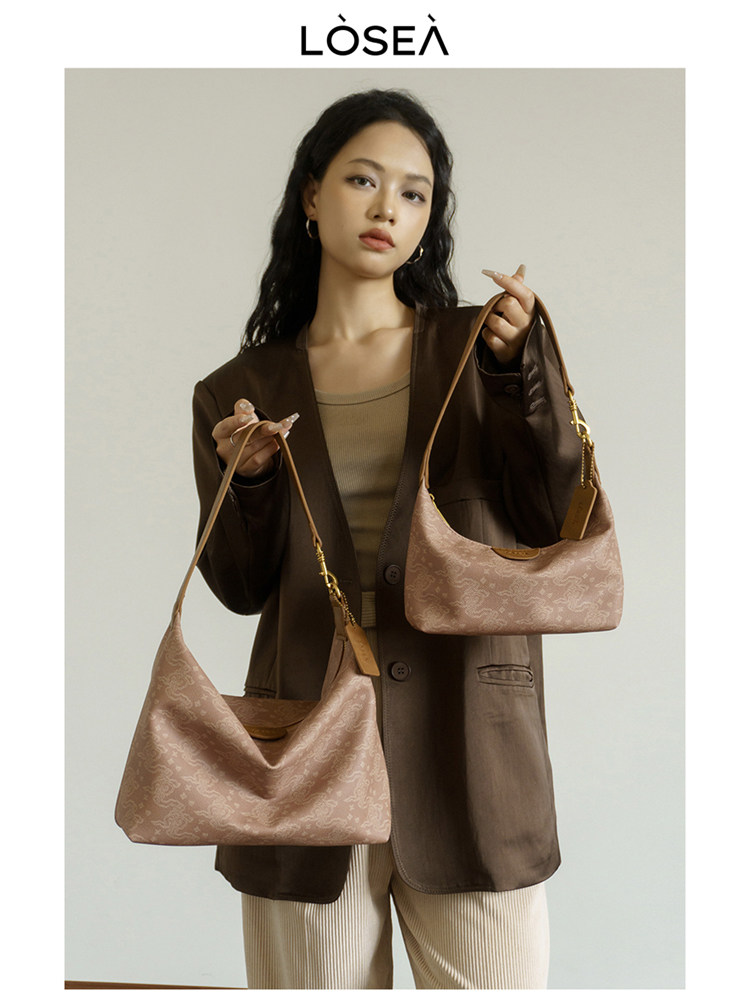 Model holding two pink monogram shoulder bags