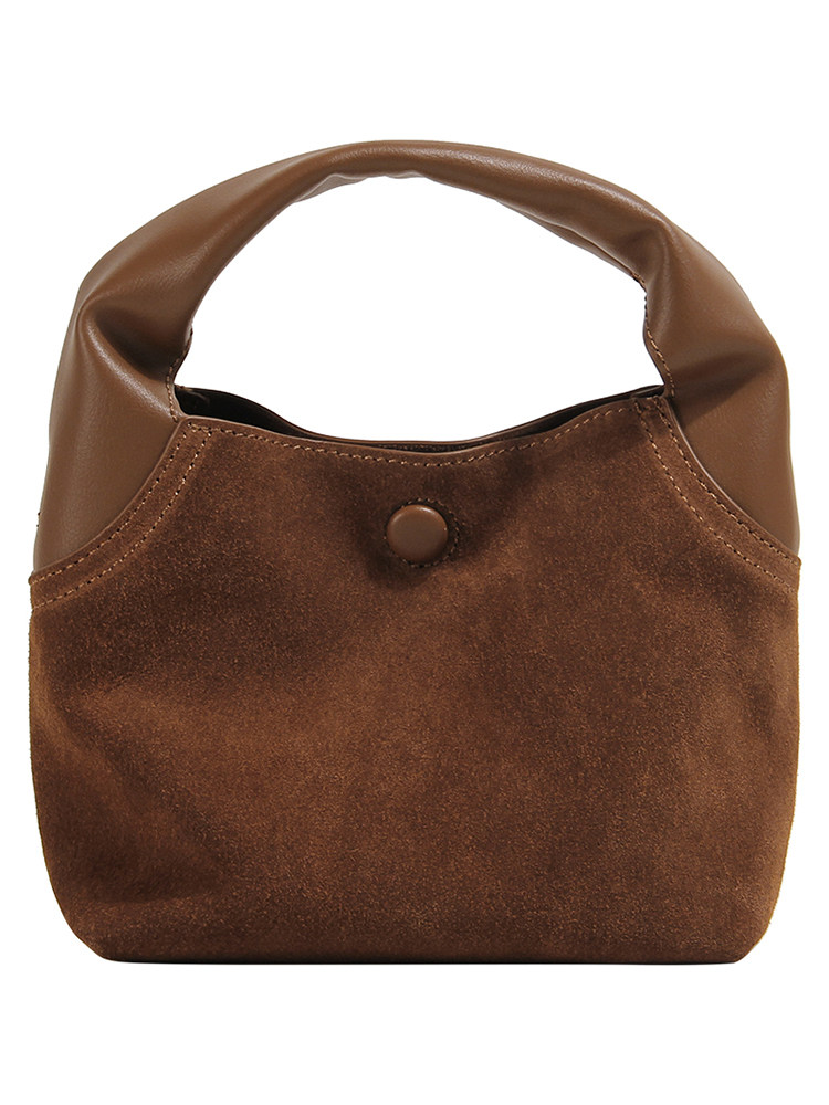 Brown suede and leather handbag on white background