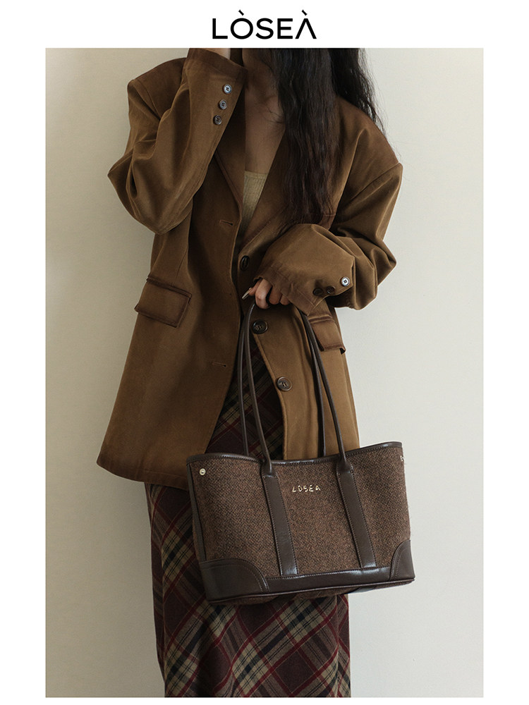 Brown oversized blazer with matching tote bag worn by a model