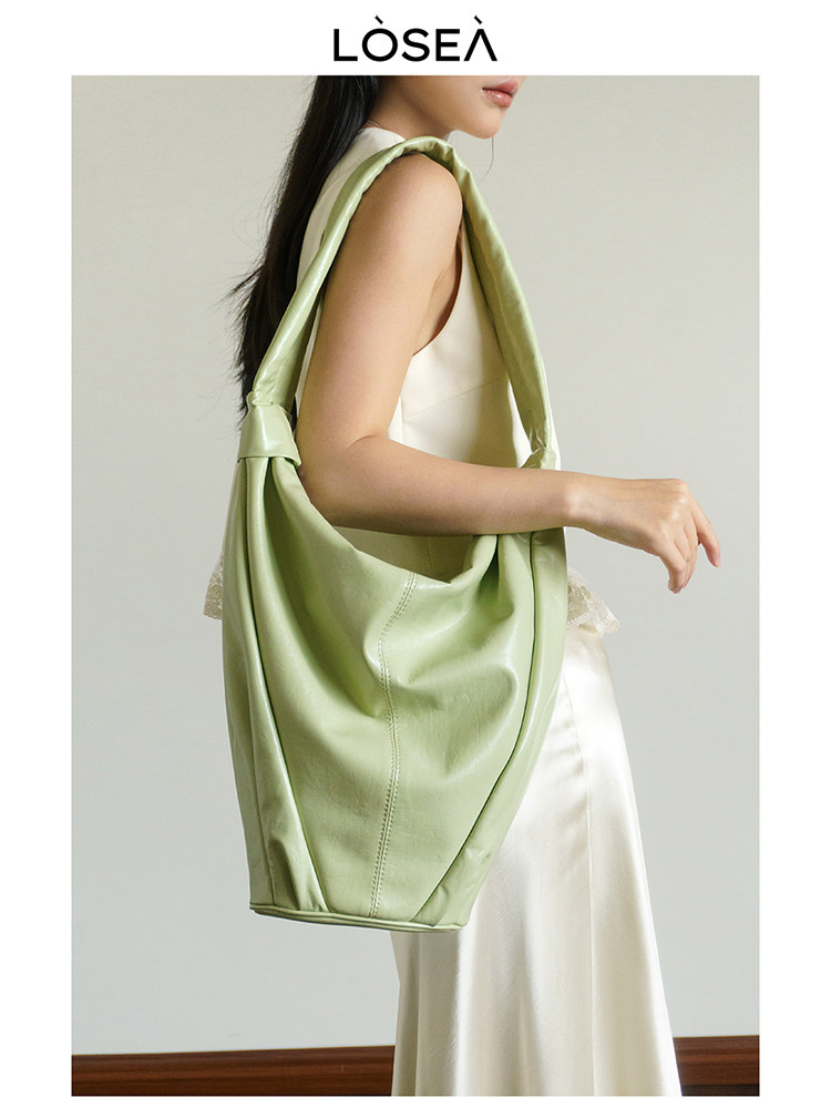 Light green oversized shoulder bag worn by a model