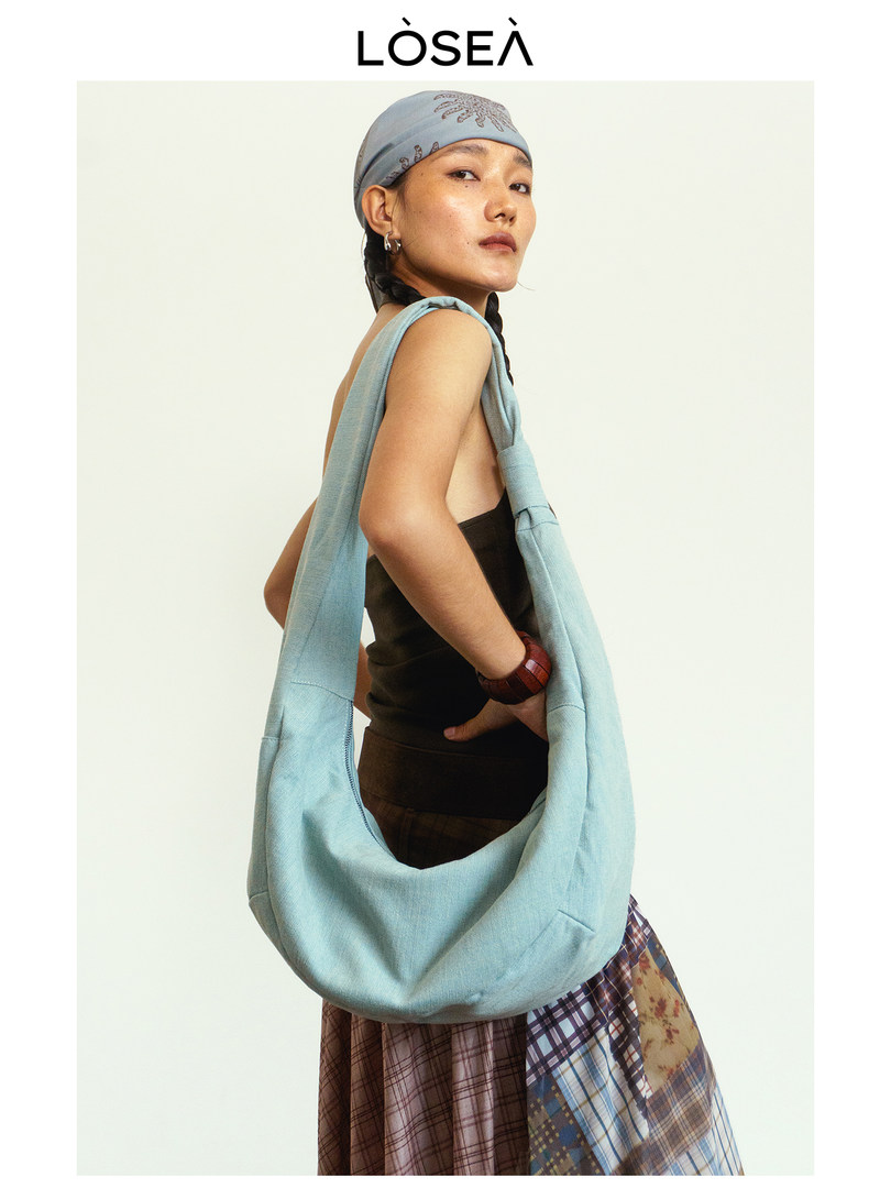 Light blue oversized shoulder bag worn by a model