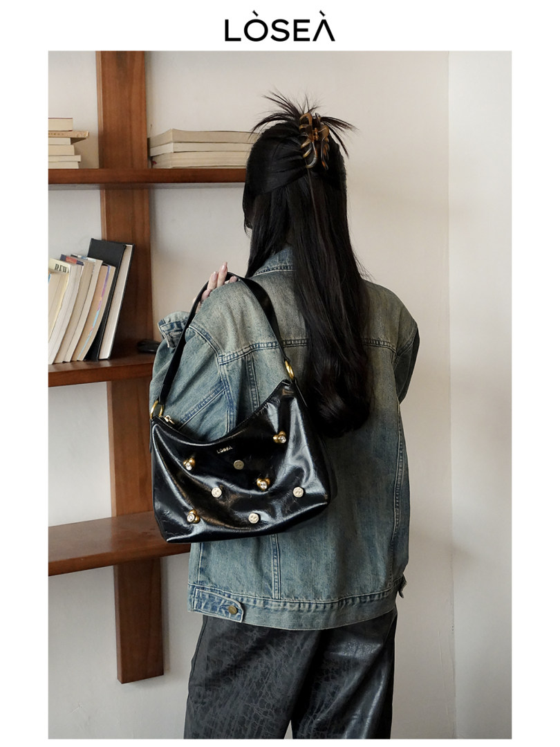 Woman wearing a denim jacket with a black shoulder bag