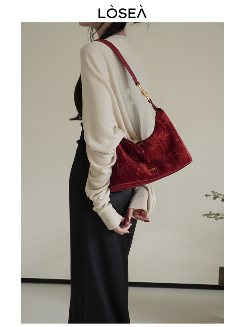 Model wearing a red shoulder handbag