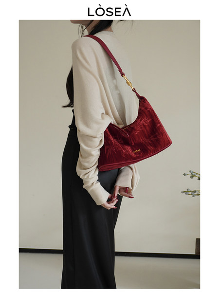 Model wearing a red shoulder handbag