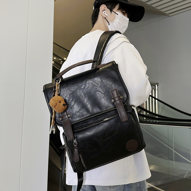 复古PU皮翻盖防水双肩包男士大容量商务潮流背包学院风大学生书包