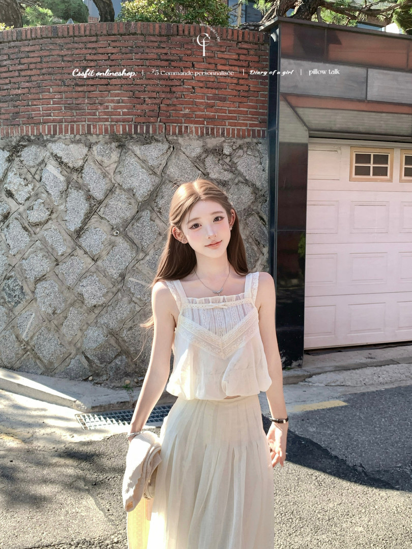 Woman wearing a light cream sleeveless dress outdoors