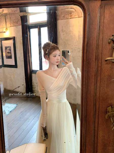 White off-shoulder long dress worn in a mirror selfie