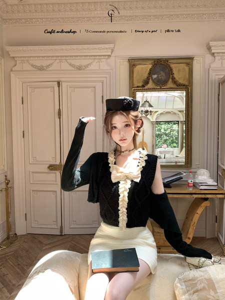 Model wearing a black and white elegant fashion outfit with ruffled details