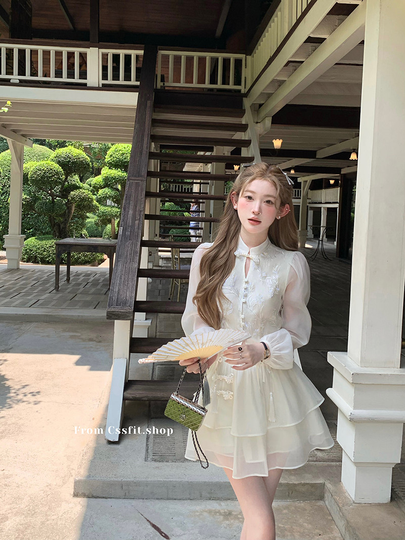 Woman wearing a white layered dress outdoors