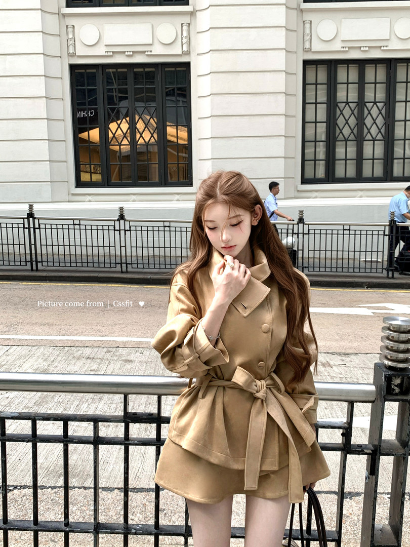 Model wearing a beige trench coat outdoors
