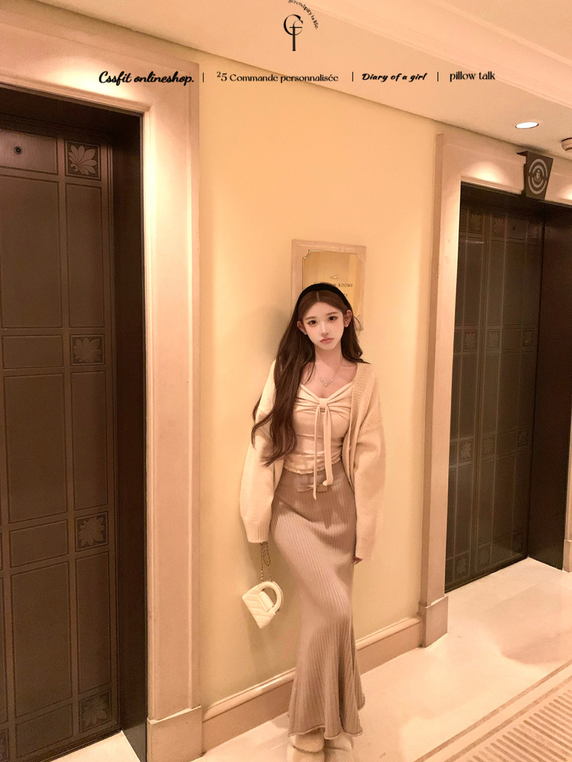 Woman modeling a cream knit cardigan and ribbed skirt outfit indoors