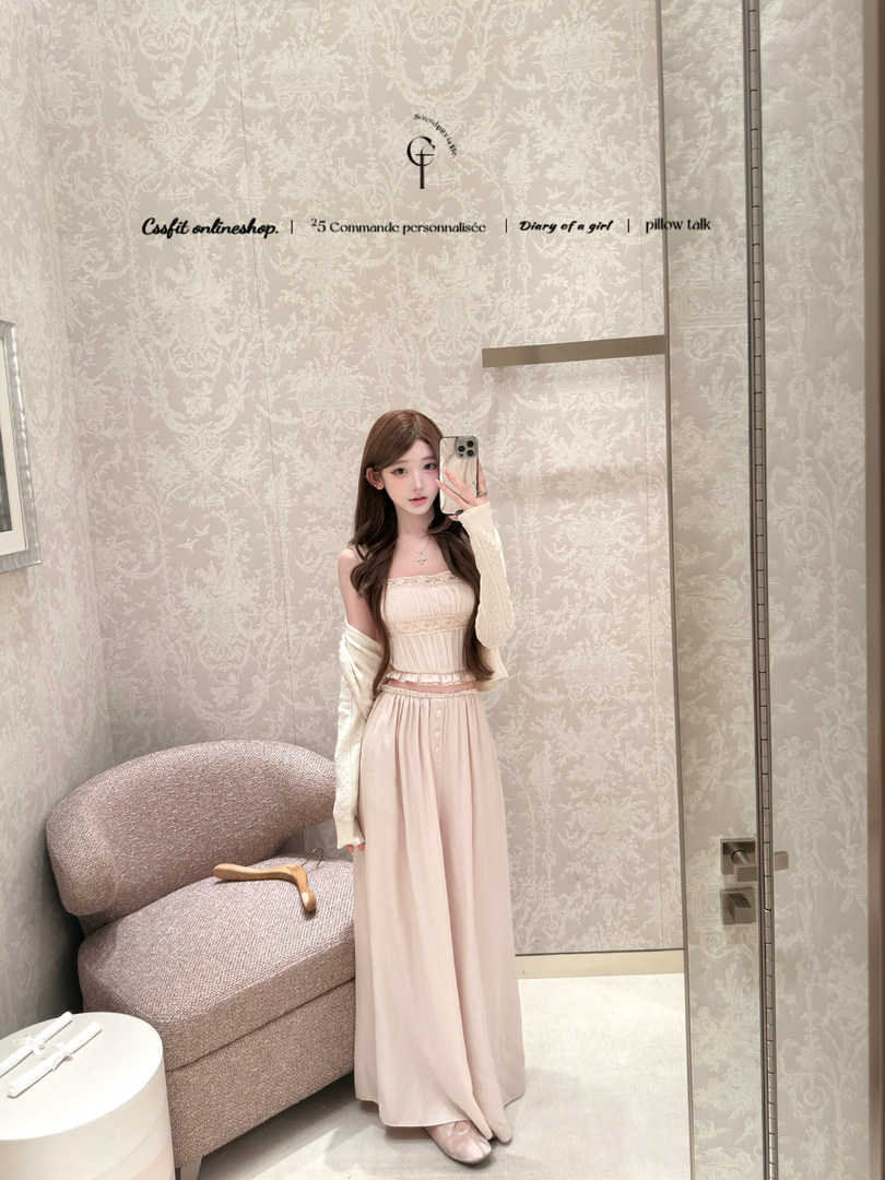 Woman wearing a light pink strapless maxi dress in a mirror selfie