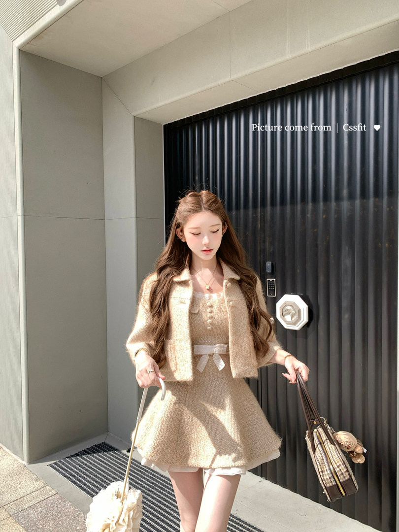 Woman wearing a beige knit cardigan and dress set outdoors
