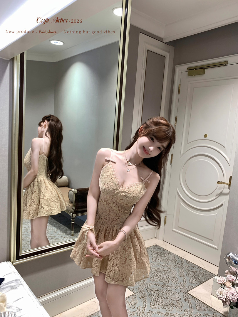 Beige lace mini dress worn by a model indoors