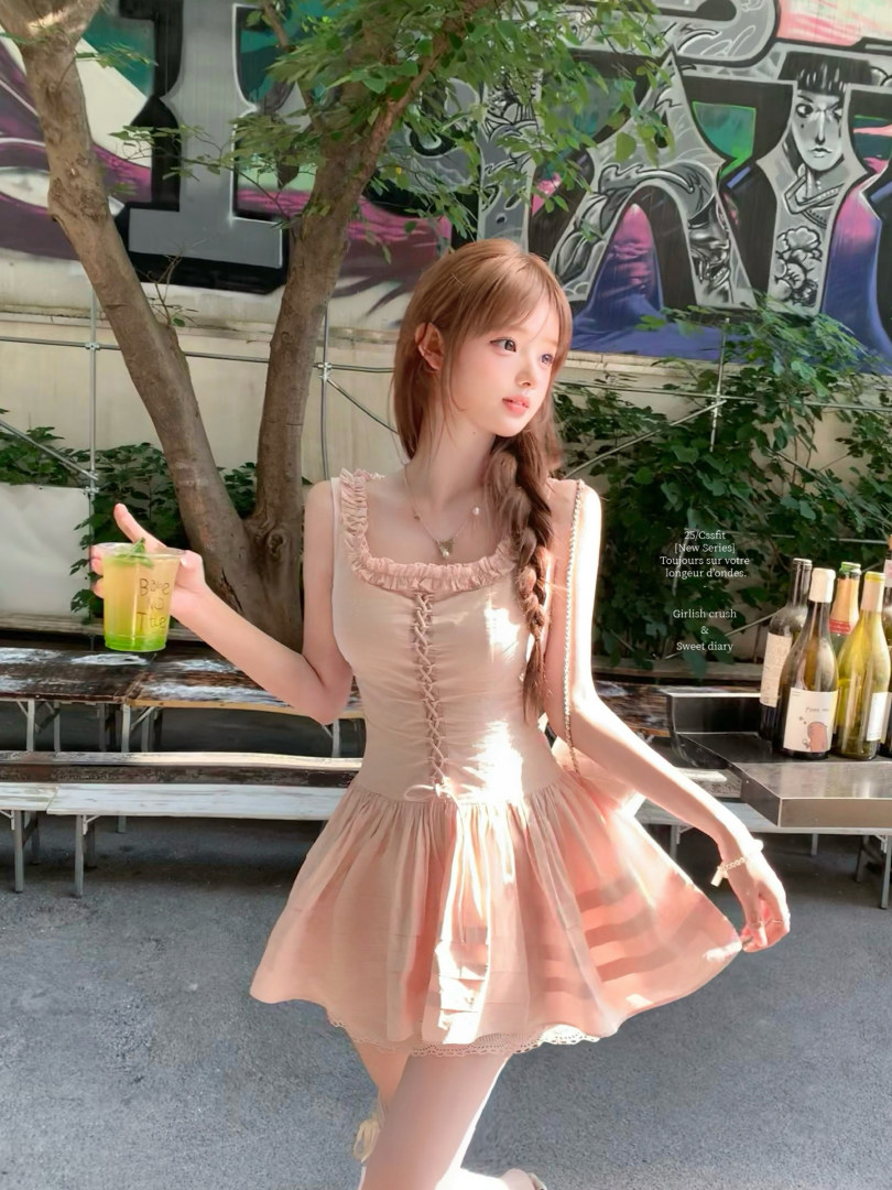 Woman wearing a light pink ruffled dress outdoors