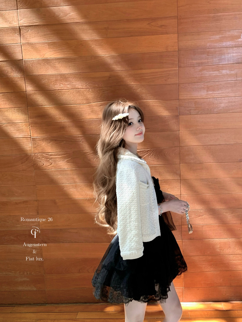 Young woman modeling a white textured jacket with a black skirt
