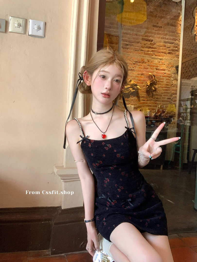 Black floral spaghetti-strap mini dress worn by a model