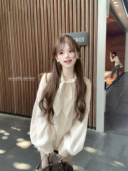 Cream long-sleeve blouse worn by a model