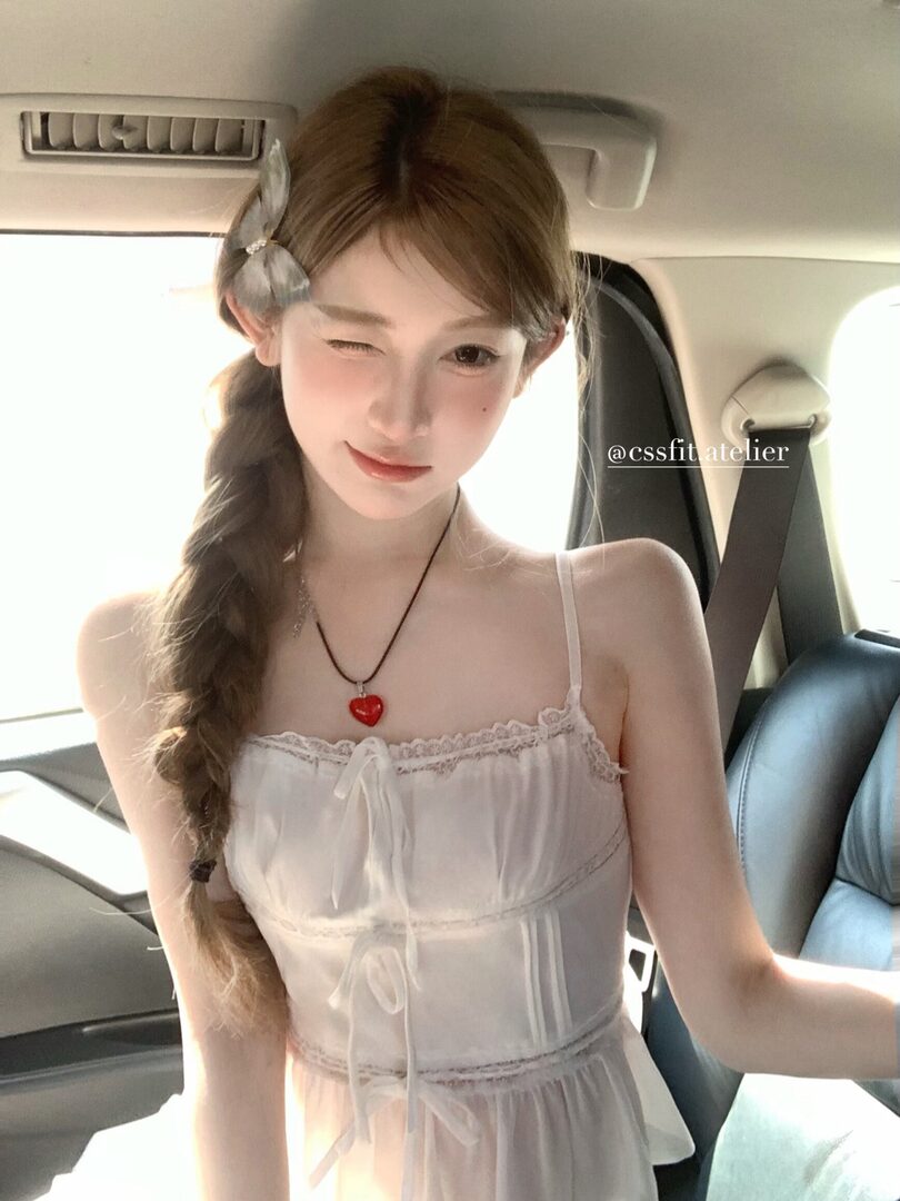 White sheer lace-trim slip dress worn by a woman
