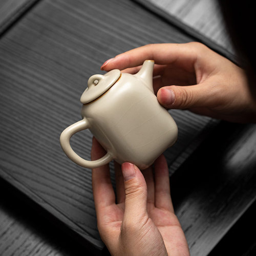 Bean yellow Ru kiln teapot with spherical filter hole, clos
