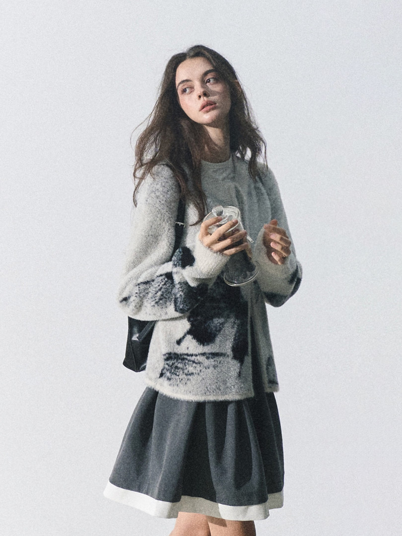 Model wearing a cozy oversized sweater and dark skirt
