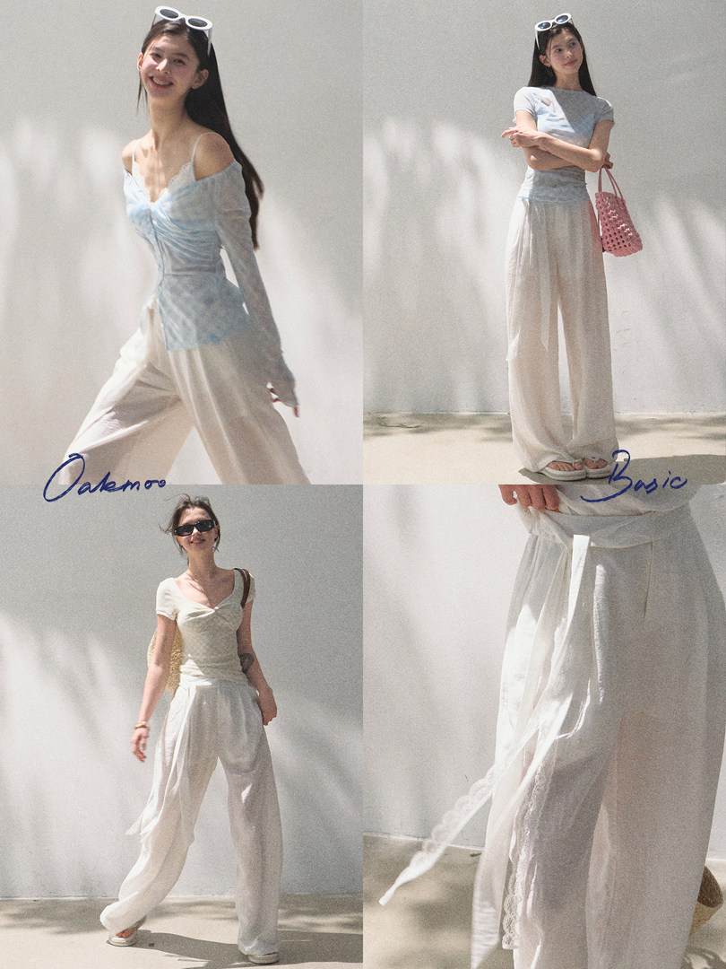 Model wearing a light blue off-shoulder top with white wide-leg pants