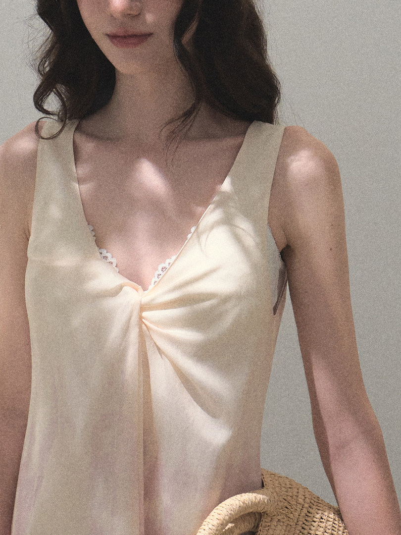 Cream satin sleeveless top worn by a model