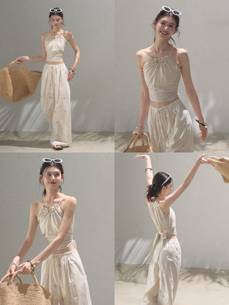 Model wearing a cream halter crop top and matching wide-leg pants set