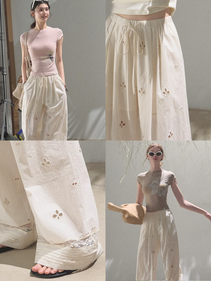 Model wearing a light pink fitted top with cream wide-leg embroidered pants